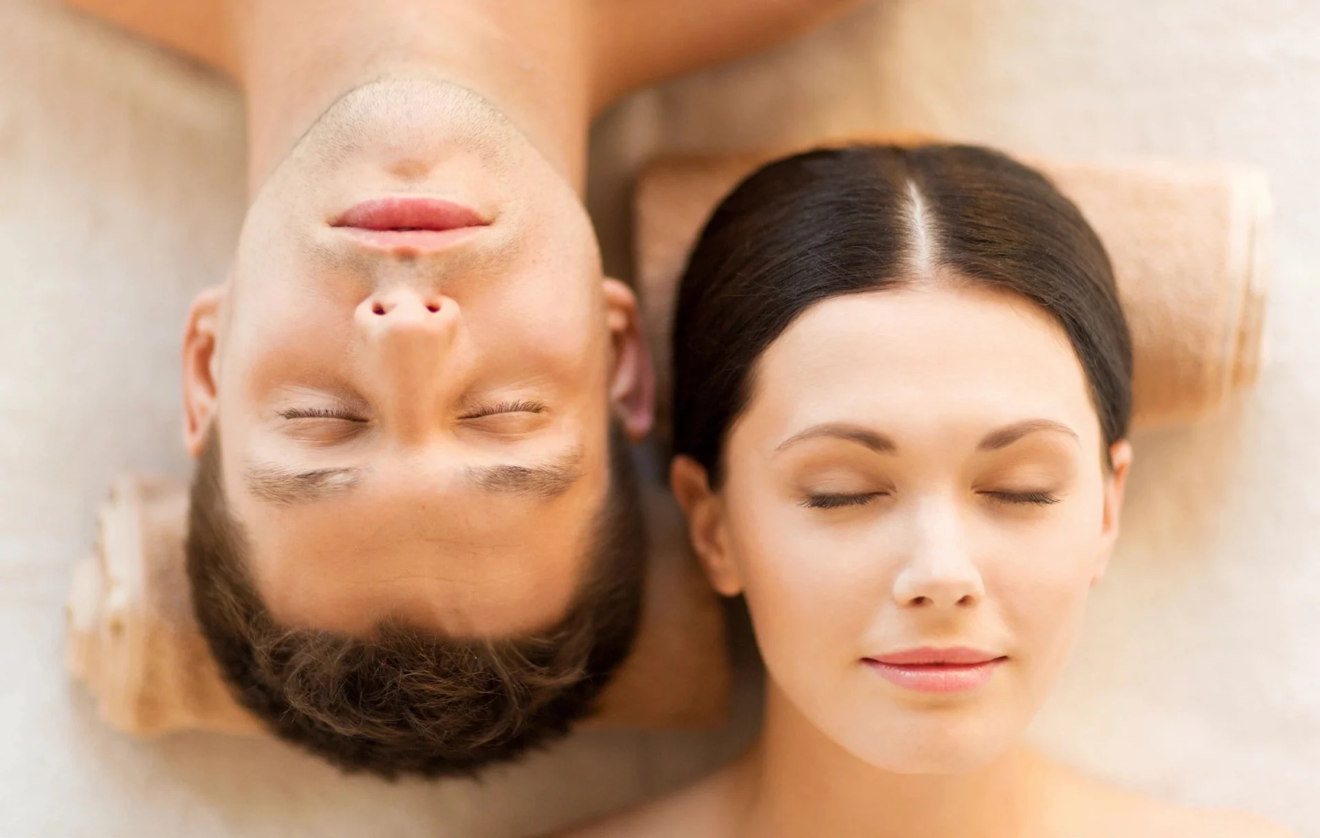 A man and woman laying on their backs.