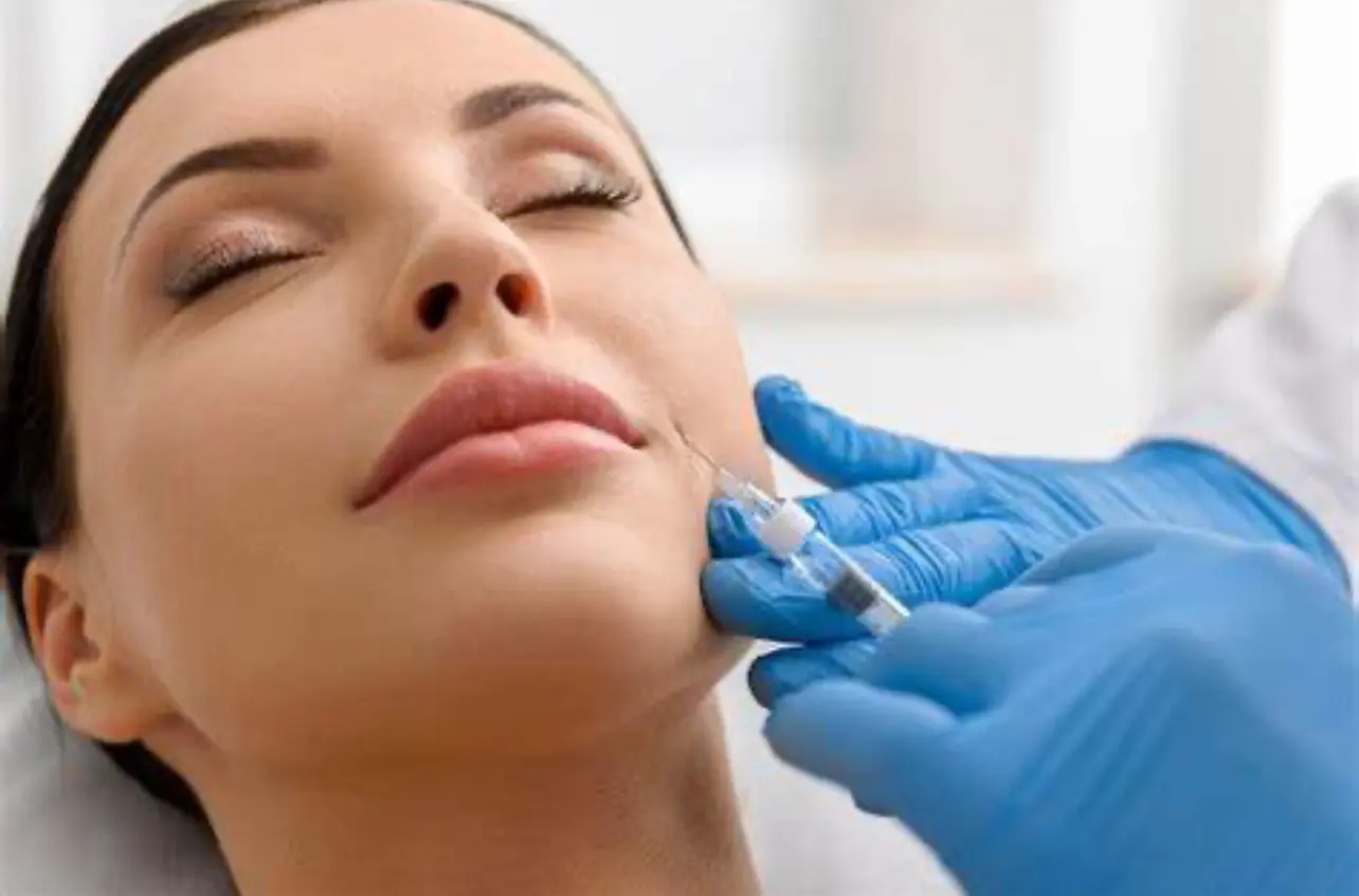 A woman getting her face waxed by an esthetician.