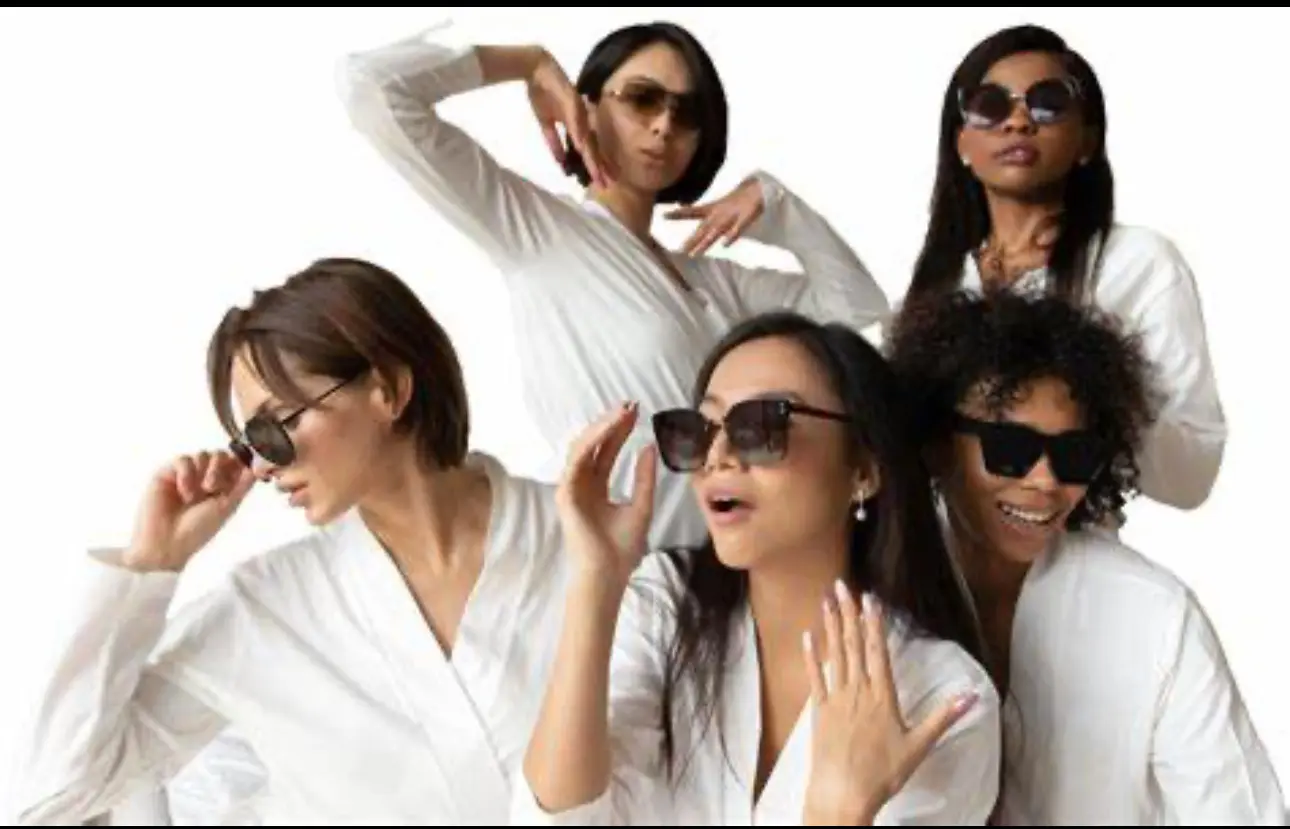 A group of women wearing sunglasses and posing for the camera.